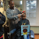 Ryan Griffin cuts a child’s hair as he reads aloud at Griffin’s barbershop in Ypsilanti, Mich.
The Fuller Cut via Facebook